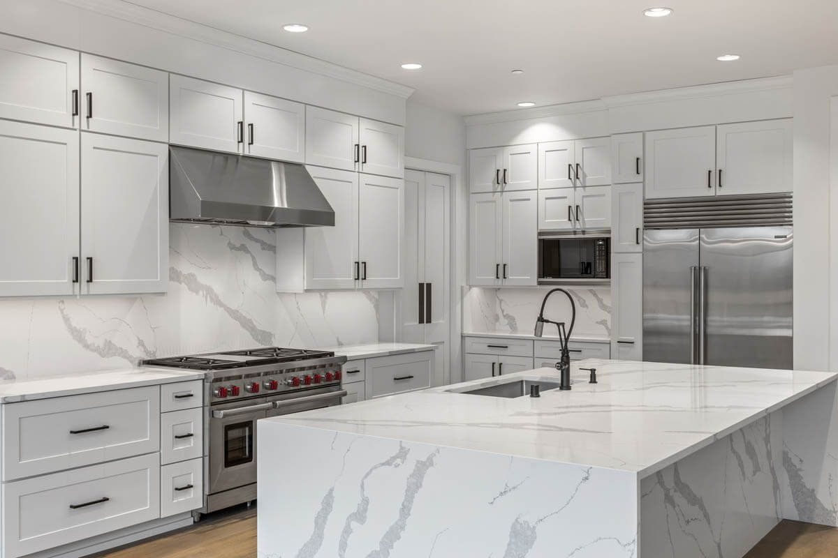 Kitchen with a marble island and stainless appliances