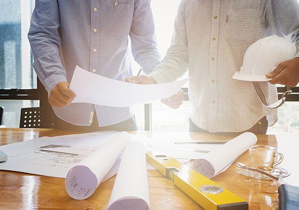 Home Plans NW designers reviewing drawings with a client